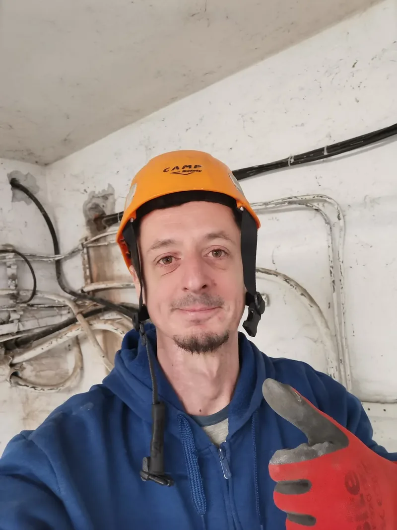 Electrician electroSOS cu cască de protecție, pe șantier